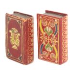 Two tooled red leather needle packet boxes, of book form one decorated with a lyre in gilt and