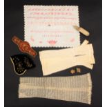 A mixed lot of costume and needlework, comprising an alphabetical sampler over numerals and five