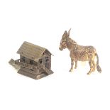 Two brass novelty tape measures, comprising an example in the form of a mule or donkey, the