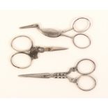 Three pairs of 19th Century steel scissors, comprising a French pair, the arms shaped and engraved