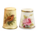Two Worcester porcelain thimbles comprising a puce ground example decorated with a bird on a