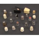 A collection of thimbles and two thimble cases, comprising five 19th Century ivory examples, eight