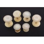 Four mother of pearl top reel holders, a waxer and emery, comprising a set of three reel holders,