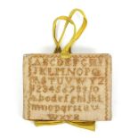 An early 19th Century sampler form needle book, one side with upper and lower case alphabet and