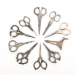 Nine pairs of steel bladed scissors, mostly with English silver hall marked arms and loops