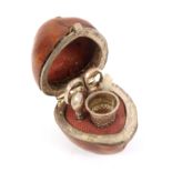 A rare miniature mid 19th Century sewing companion for a doll housed in a hazelnut, the white