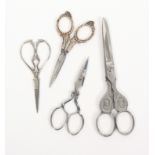 Four pairs of scissors, comprising a pair with steel blades to floral silver arms and loops, 10cm, a