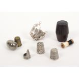 Thimbles and thimble cases, comprising an attractive early Georgian silver thimble guard with