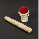 An early 19th Century ivory pin cushion and matching needle case, of ‘stacked brick pattern’, the