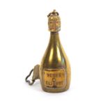 A brass novelty tape measure in the form of a bottle of Veuve Cliquot champagne, the complete