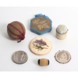 Seven 19th Century and early 20th Century pin cushions and discs, comprising a pierced and carved
