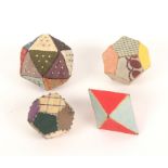 Four patchwork silk pin cushions, comprising two dodecahedron form examples with pin stuck edges