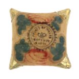 A rare commemorative pin cushion, of square cushion form in painted velvet with gold foil corners,