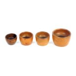 Four 19th Century knitting wool ball cups, all in lignum vitae, largest 9.5cms dia.     (4)