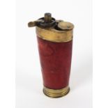 An early 19th century three way gun flask of oval tapering from with red leather covered body, 10.