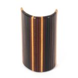 A rare Tunbridge ware kettle holder, formed from strips of variant timbers mounted on a leather