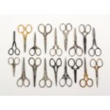 Eighteen pairs of 20th Century scissors, mostly steel with decorative arms and loops, largest 9.