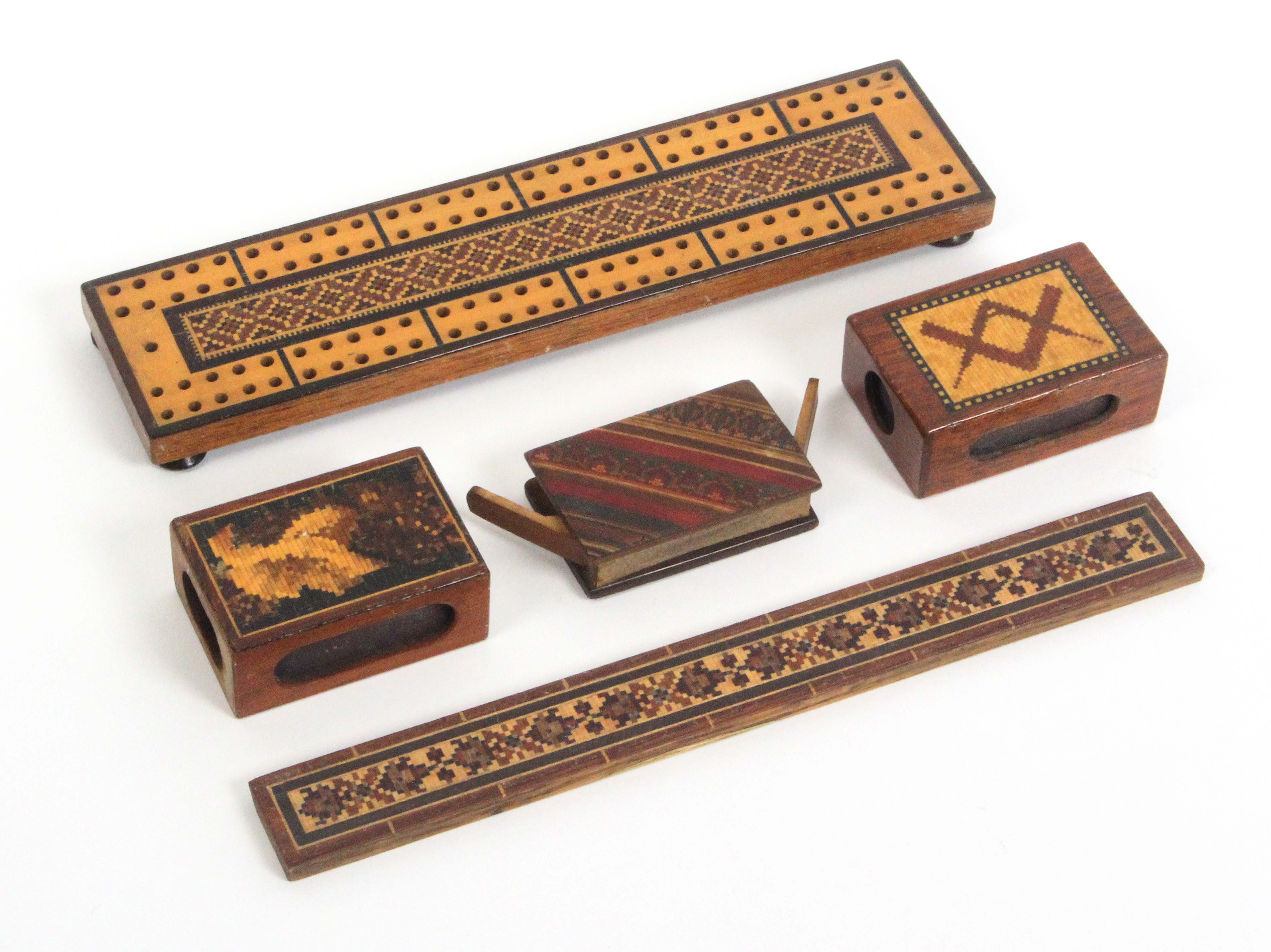 Tunbridge ware – four pieces and another, comprising a geometric mosaic cribbage board, 22.5cms, a