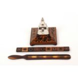 A Tunbridge ware inkwell, letter knife and ruler, the inkwell on angled square base raised on bun