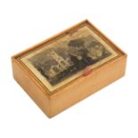 An early white wood and print decorated Tunbridge ware pin hinge box, the lid with a titled print ‘