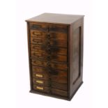 An Edwardian walnut shop counter chest, of ten drawers, the panel sides inscribed ‘Briggs Court