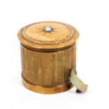 A gilt brass combination tape measure and thimble case, of reeded cylinder form the domed lid with a