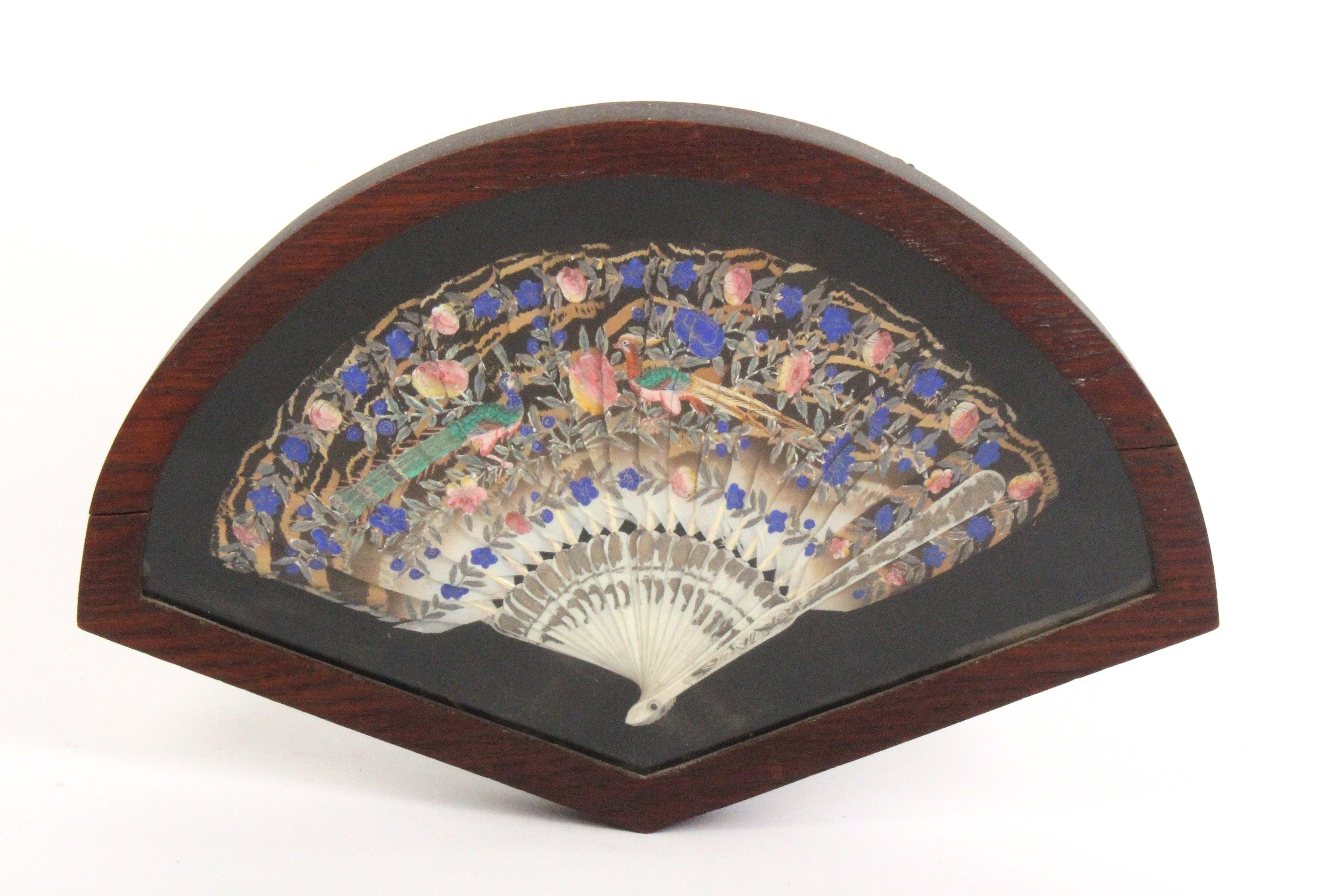 A mid 19th Century feather fan, probably Chinese, the feathers painted with two exotic birds amid