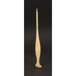 An unusual early 19th Century bone crochet hook, the handle formed as a lady’s leg and shoe, 16.7cm.