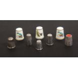 Eight thimbles, comprising two early 19th Century silver examples, both with deep decorated
