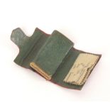A small Regency grained red leather wallet form sewing companion, impressed in gilt ‘Forget Me Not’,