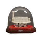 A 19th Century pierced ivory model of an early steam train under a glass dome, floral and leaf
