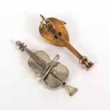 Two novelty metal tape measures, comprising a white metal violin or cello, the complete printed tape