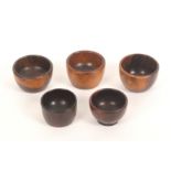 Five 19th Century knitting wool ball cups, all in lignum vitae, largest 7.5cms dia.      (5)