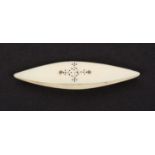 An early 19th Century ivory shuttle, each side with a conforming panel of burnt circle decoration,