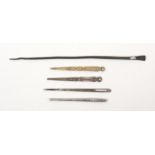 Four bodkins and a Roman bronze needle, comprising two decorative silver bodkins, another plain, and