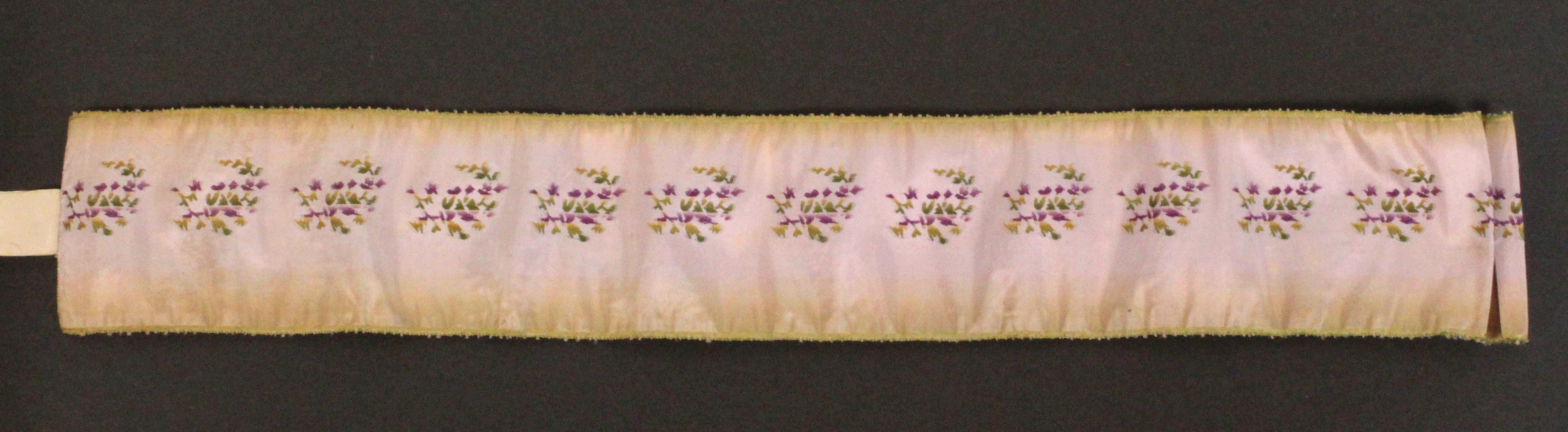 A 19th Century needle roll, the exterior in faint purple silk embroidered with flowers, the interior - Image 2 of 2