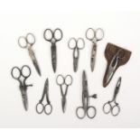 Ten pairs of steel button holing scissors, five of adjustable form, one with leather sheath, largest