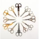Twelve pairs of 20th Century scissors, most with decorative elements, two pairs with silver handles.