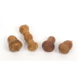 Three thimble cases and a needle case, comprising a vegetable ivory acorn form example with