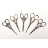 Five pairs of late 19th Century/early 20th Century steel scissors, with attractive silver arms and