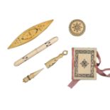Five 19th Century ivory Madras sewing tools, with burnt circle decoration comprising a needle