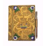 A late 19th/early 20th Century notebook, the covers and spine in gilt metal filigree, the cover with