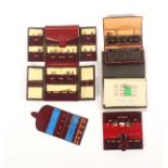 Four leather needle wallets and another, comprising a red leather gilt lined example for ‘John James