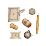 Seven 19th Century ivory Madras sewing tools, with burnt circle decoration comprising a needle book,