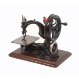 A late 19th Century Wilcox and Gibbs sewing machine, the platform with adjustable ‘stitches to an