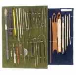 Crochet and netting tools, a rectangular green velvet mounted display of variant crochet hooks and