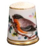 An English porcelain thimble circa 1840, painted with a bird on a flowering branch between gilt