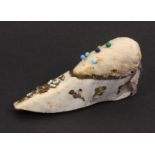 A Georgian silk pin cushion in the form of a shoe, pale blue silk decorated with coiled wire and