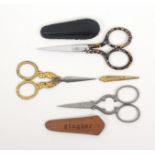 Three pairs of scissors, comprising an attractive Regency pair with tapering oval section steel