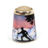 A Norwegian silver and enamel thimble by Askel Holmsen, with a lone skier set against an extensive